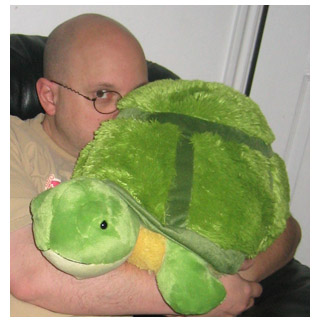 Howard snuggles the Squishable tortoise